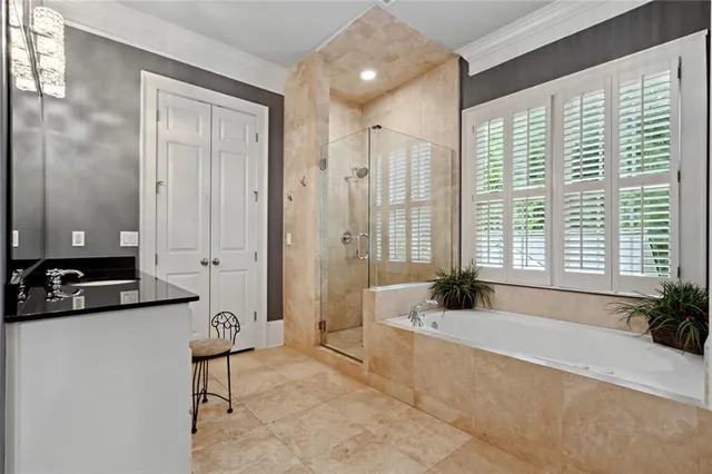 a spacious bathroom with a tub sink and mirror