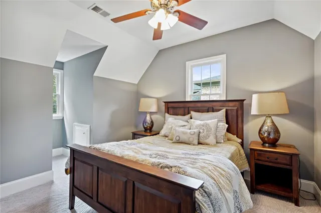a bathroom with a granite countertop toilet sink and mirror