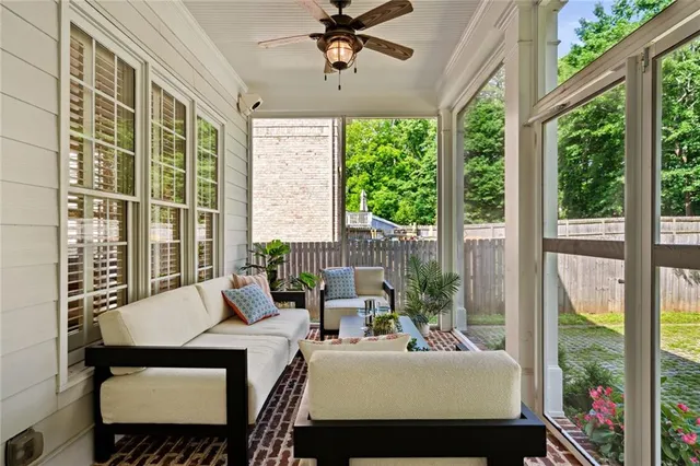 a bedroom with furniture and a large window