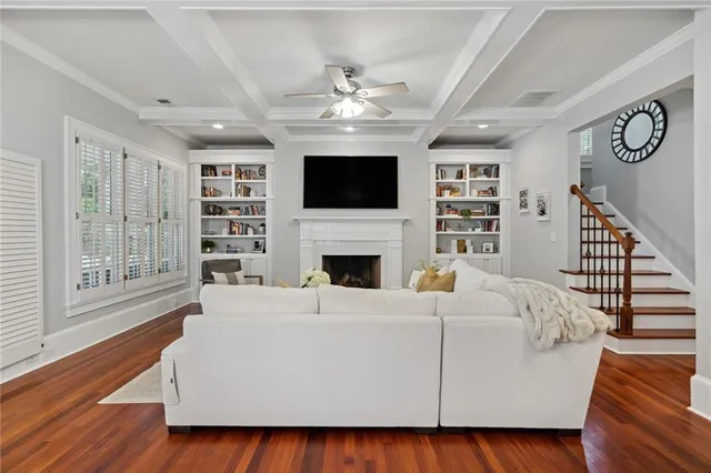 a living room with furniture fireplace and flat screen tv