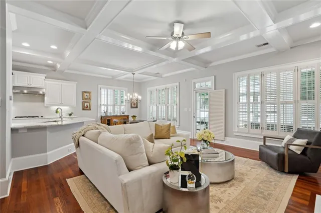 a living room with furniture kitchen and a large window