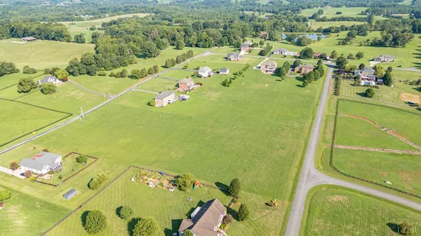a view of a green field with sitting area