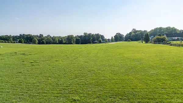 a view of a field with an ocean