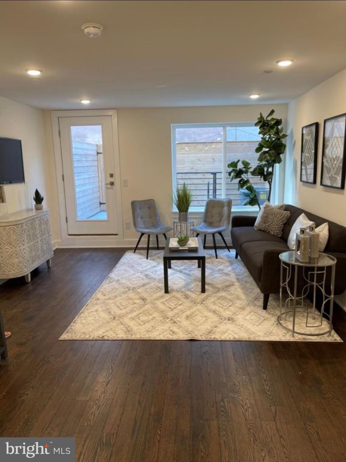 1012 South 20th Street, Unit 4 Philadelphia, PA 19146 - Photo 3 of 9 a living room with furniture and a wooden floor