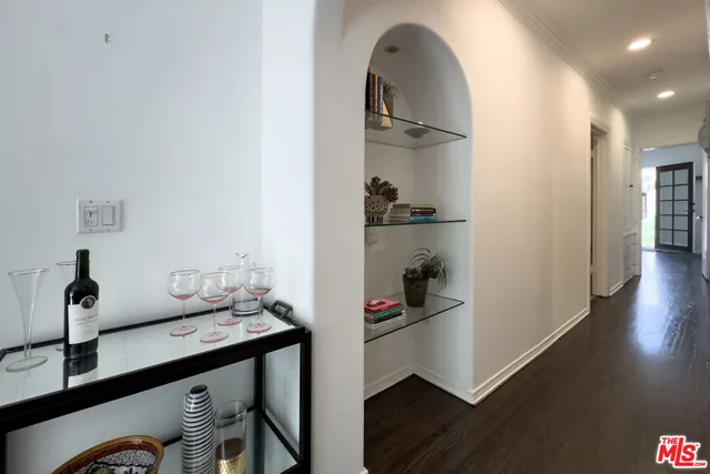 a view of a livingroom with wooden floor and a ceiling fan