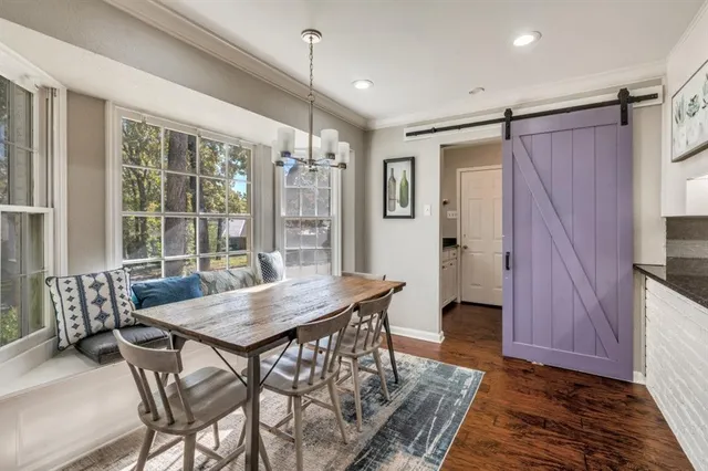 a view of a dining room with furniture and window