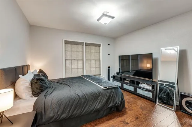 a bedroom with a bed and a flat screen tv