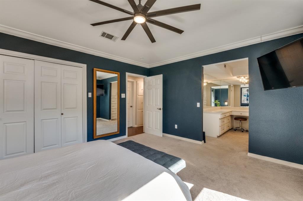 7544 Madeira Drive Fort Worth, TX 76112 - Photo 20 of 25 a bedroom with a bed and a chandelier