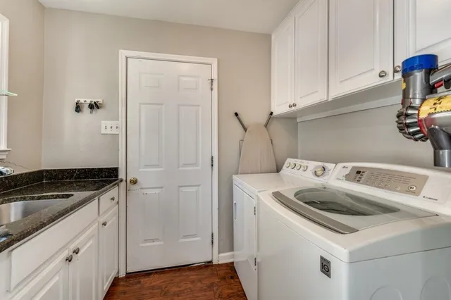a utility room with sink dryer and washer