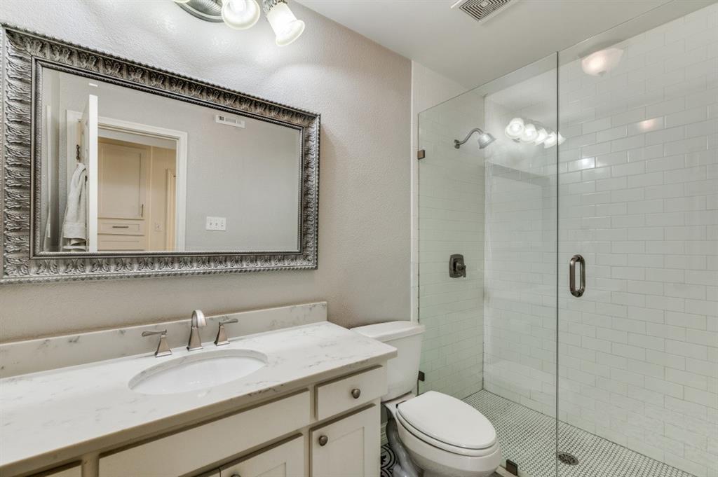 7544 Madeira Drive Fort Worth, TX 76112 - Photo 23 of 25 a bathroom with a granite countertop sink mirror toilet and shower