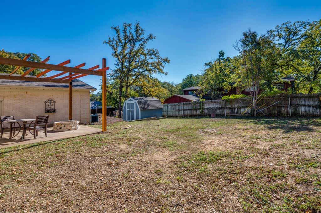 7544 Madeira Drive Fort Worth, TX 76112 - Photo 24 of 25 a view of a backyard with table and chairs potted plants and large tree