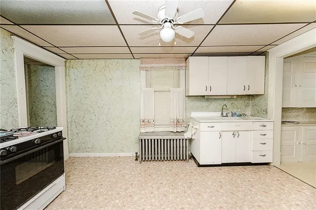 a kitchen with granite countertop a stove and a sink