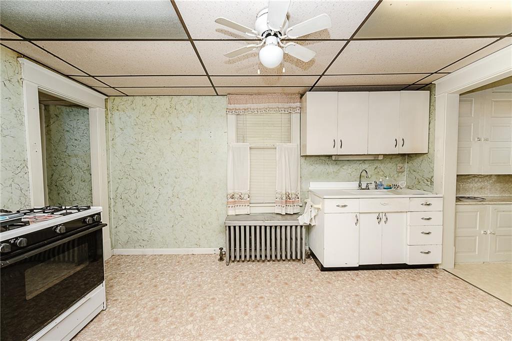 307 Allison Road Clymer, PA 15728 - Photo 5 of 22 a kitchen with granite countertop a stove and a sink