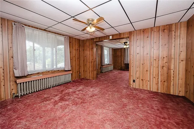 a view of a livingroom with wooden floor and windows