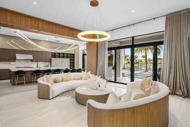 a kitchen with stainless steel appliances granite countertop table chairs sink and stove