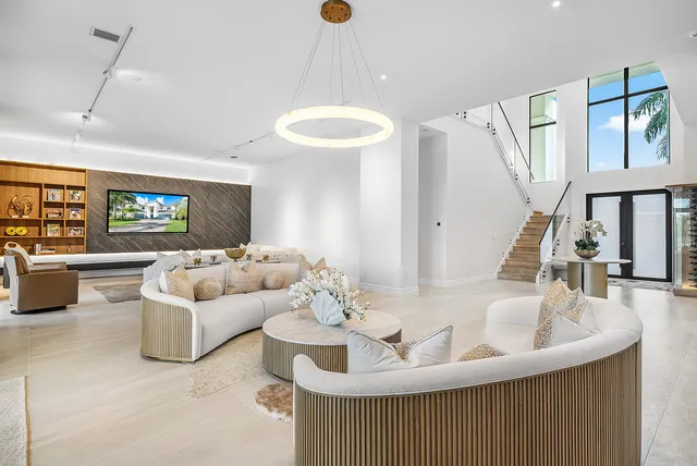 a large kitchen with stainless steel appliances kitchen island a large counter top a stove a chimney a sink and a refrigerator