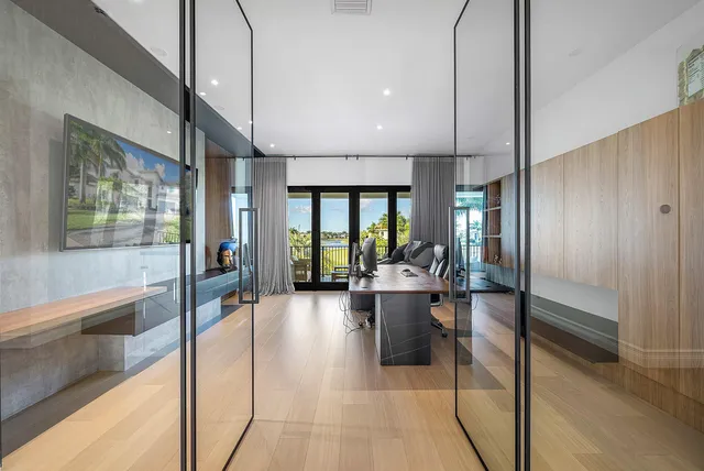 a view of swimming pool with lounge chair and palm trees
