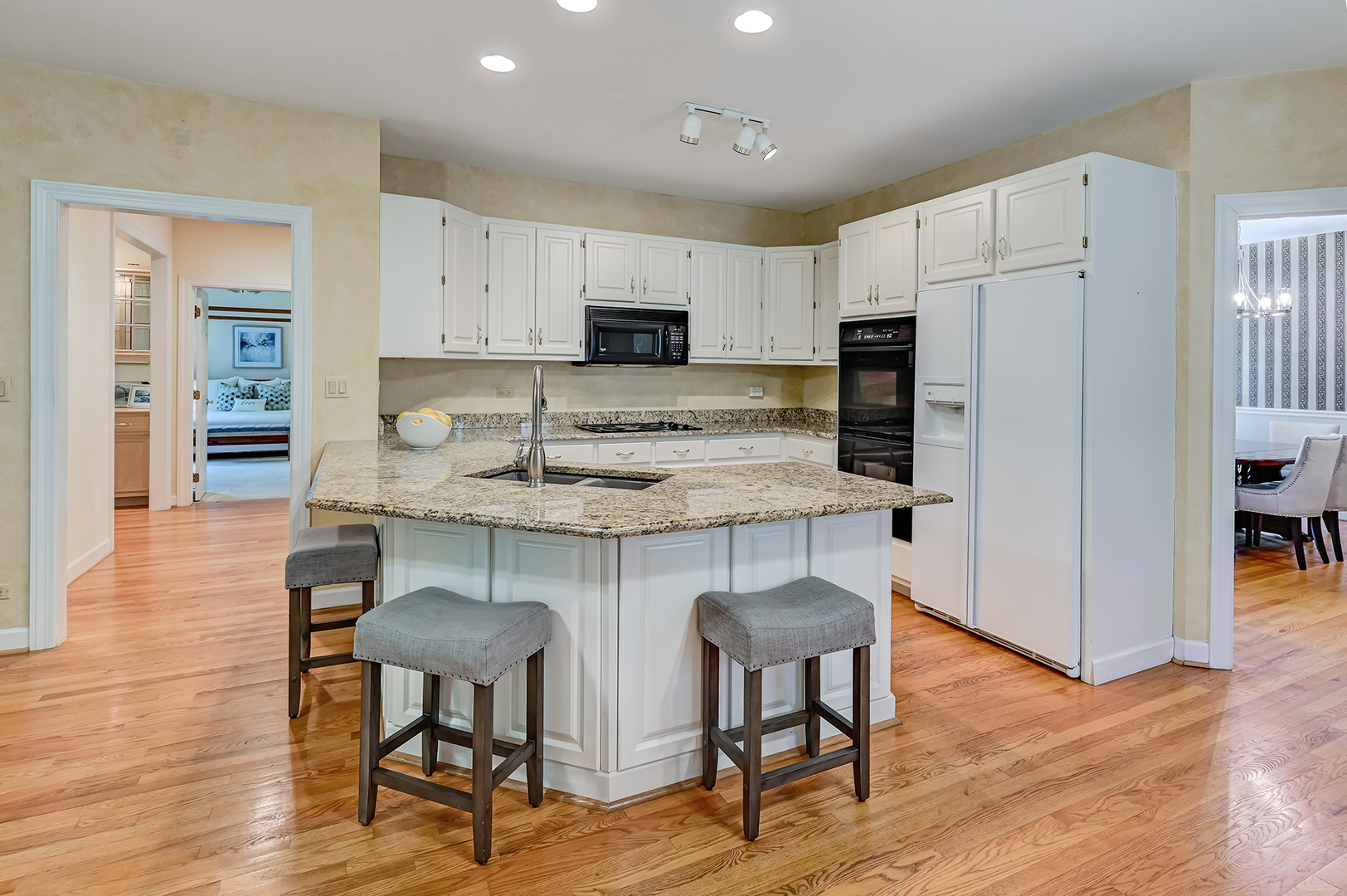 3 Berkshire Lane Burr Ridge, IL 60527 - Photo 14 of 40 a kitchen with kitchen island a white cabinets and wooden floor