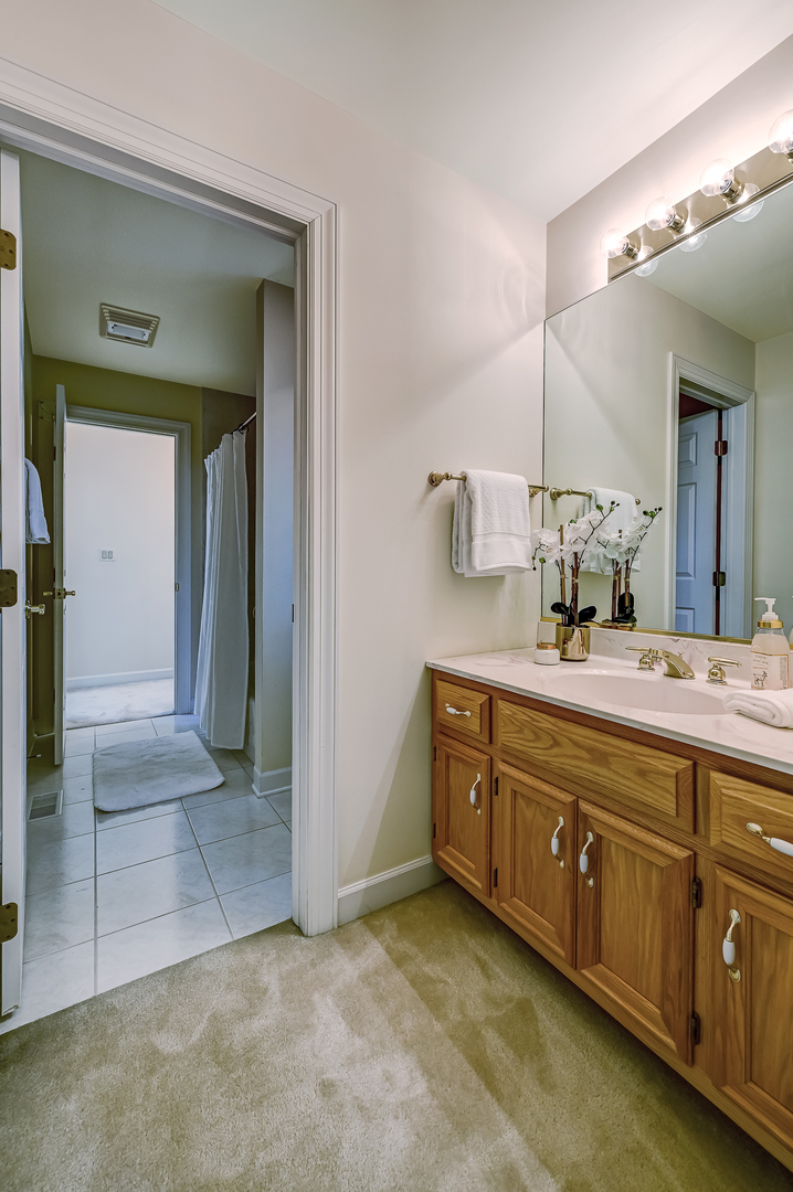 3 Berkshire Lane Burr Ridge, IL 60527 - Photo 26 of 40 a large bathroom with a double vanity sink and a mirror