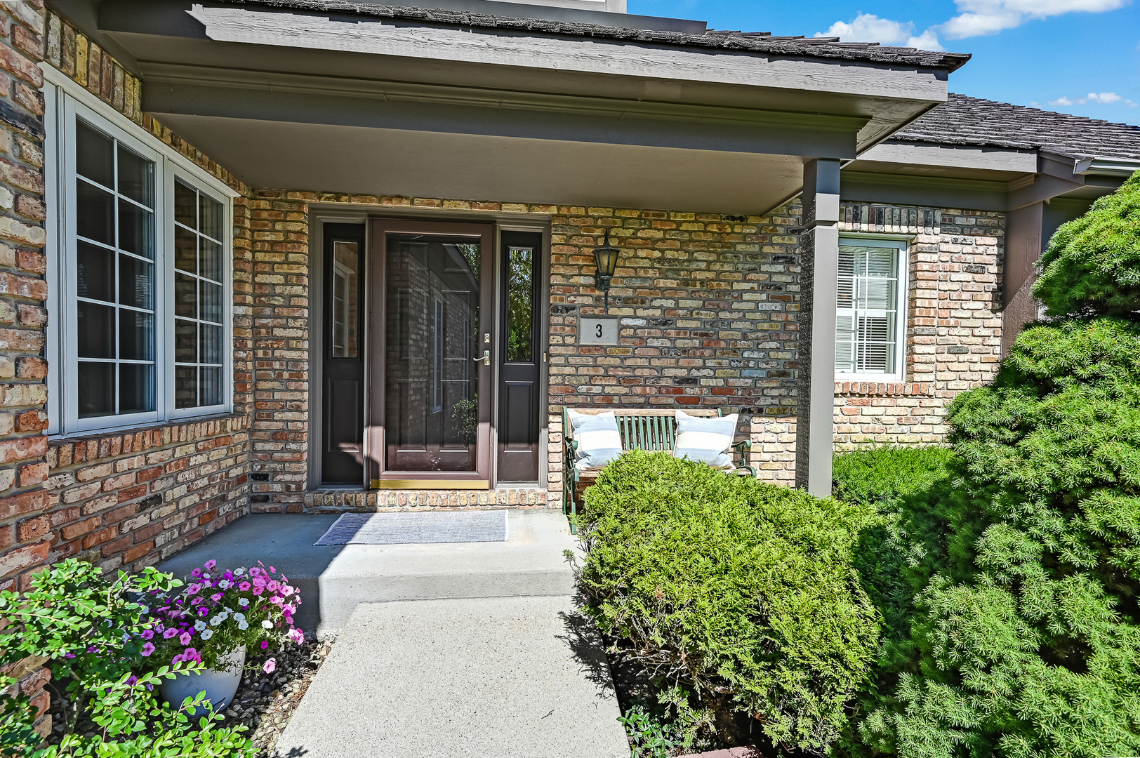 3 Berkshire Lane Burr Ridge, IL 60527 - Photo 37 of 40 a front view of a house with a garden