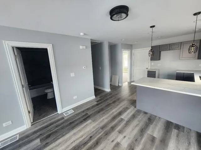 a view of a living room with a flat tv screen and a fireplace