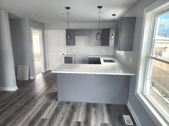 a large room with wooden floor and windows