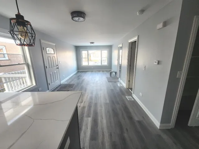 a view of hallway with wooden floor