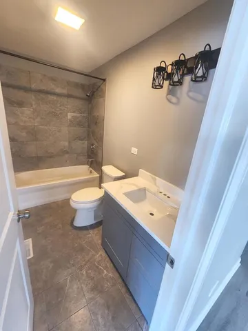 a bathroom with a sink mirror toilet and bathtub