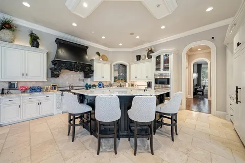 a kitchen with stainless steel appliances kitchen island granite countertop a sink and cabinets