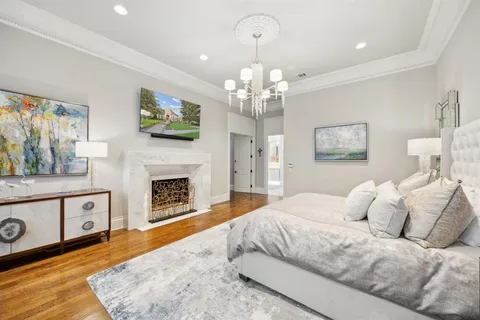 a spacious bedroom with a bed and a fireplace