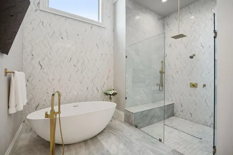 a bathroom with a tub and a shower