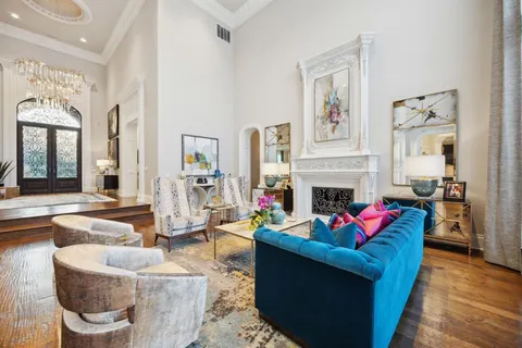 a living room with furniture large window and a fireplace