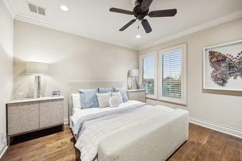 a bedroom with a large bed and a chandelier