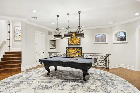 a room with table chairs and wooden floor