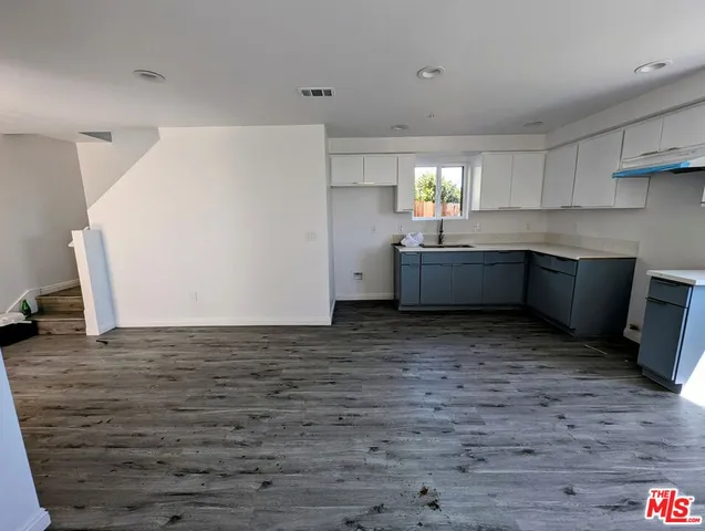 a room with cabinets and wooden floor