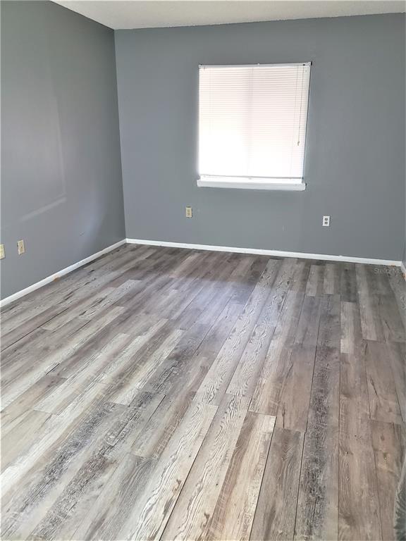 4151 South Semoran Boulevard, Unit 8 Orlando, FL 32822 - Photo 11 of 27 a view of a room with wooden floor and windows