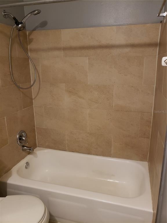 4151 South Semoran Boulevard, Unit 8 Orlando, FL 32822 - Photo 13 of 27 a bathroom with a bath tub with a shower