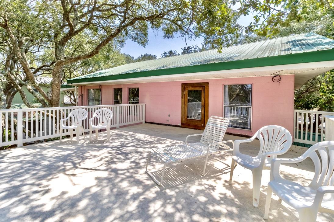 79 Garfield Street Santa Rosa Beach, FL 32459 - Photo 32 of 49 a backyard of a house with table and chairs