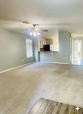 a view of a livingroom with a kitchen