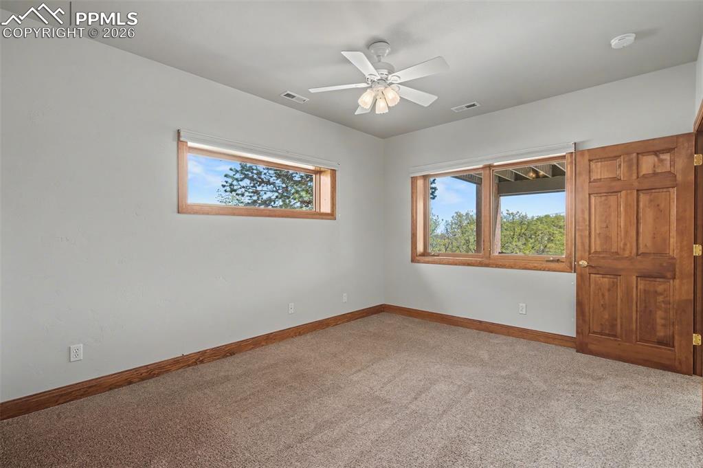 4215 Star Ranch Road Colorado Springs, CO 80906 - Photo 28 of 44 a view of an empty room with a window