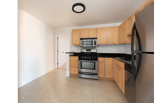 a kitchen with a refrigerator and a stove
