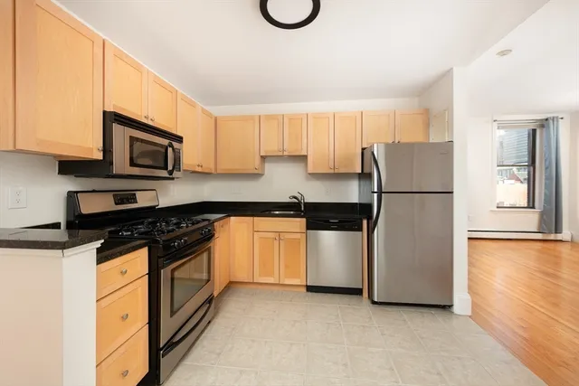 a kitchen with a sink a stove and a refrigerator