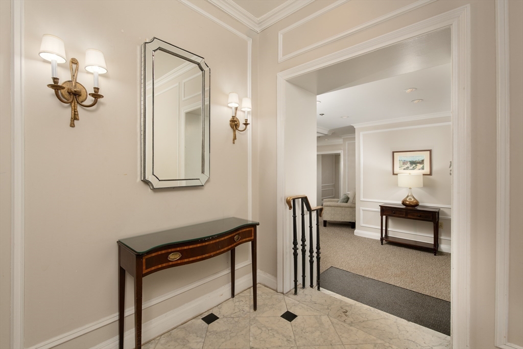 362 Commonwealth Avenue, Unit 4E Boston, MA 02115 - Photo 2 of 19 a view of a hallway with furniture and a mirror