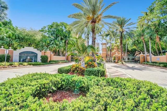 a front view of a house with fountain and garden