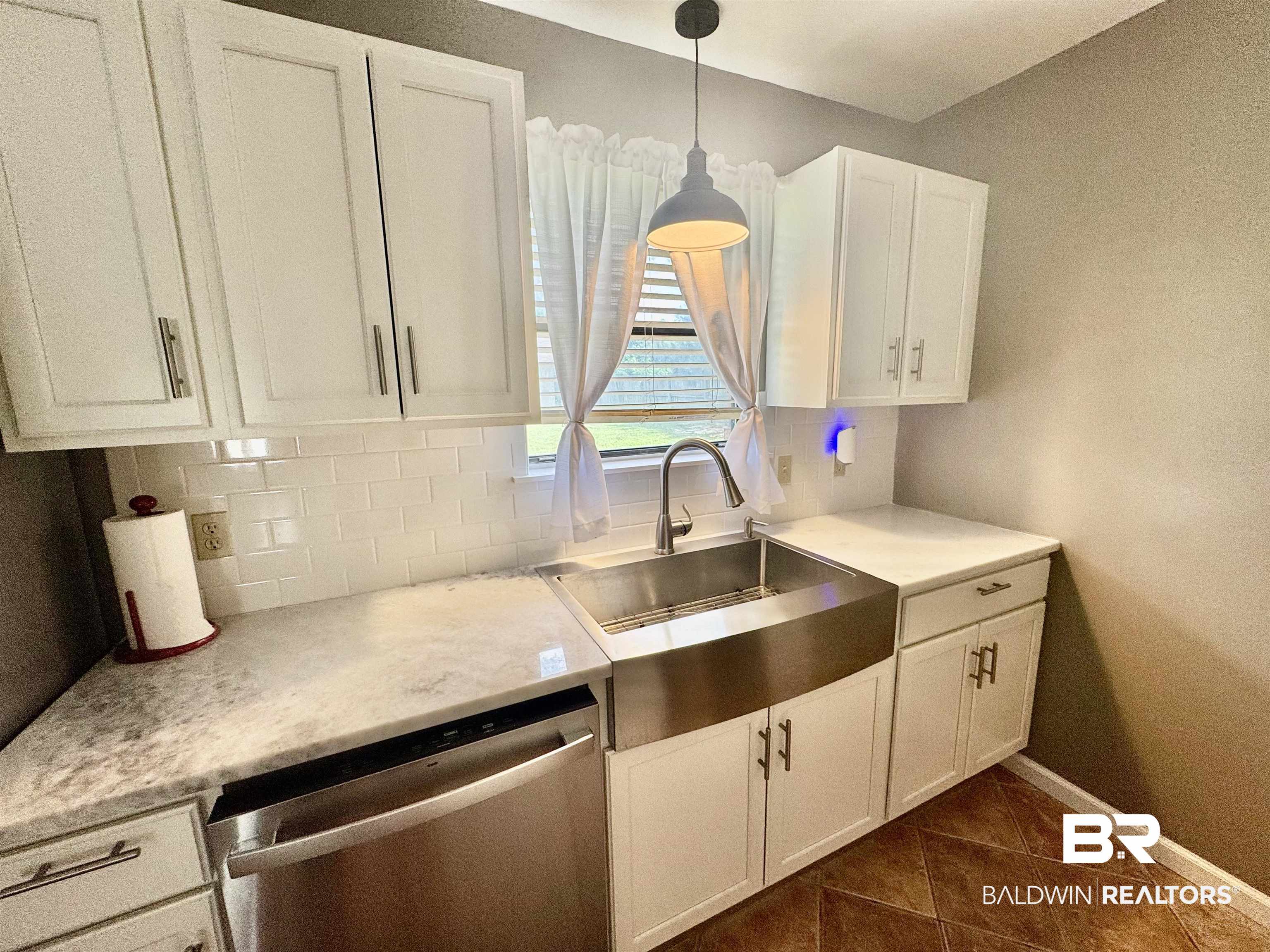 2274 Foshee Road Brewton, AL 36426 - Photo 10 of 23 Kitchen with dishwasher, white cabinets, decorative backsplash, dark tile patterned flooring, and decorative light fixtures