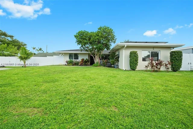 a view of a house with a yard and sitting area