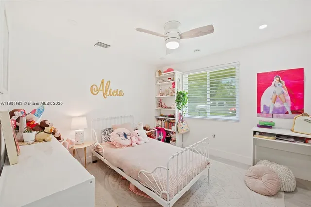 a bedroom with a bed and window