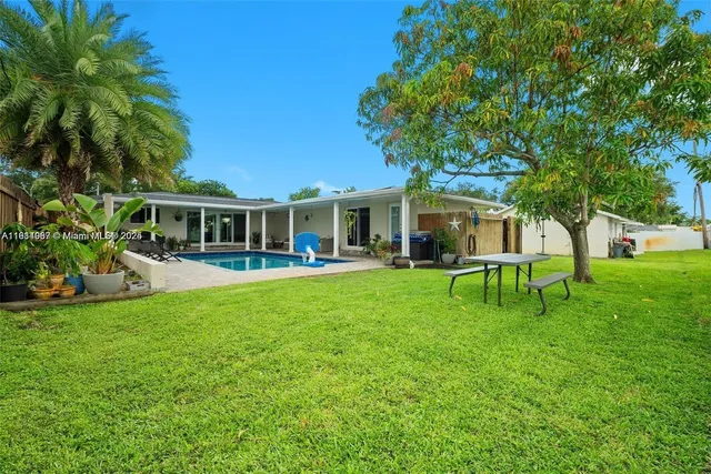 a view of a house with a backyard porch and sitting area