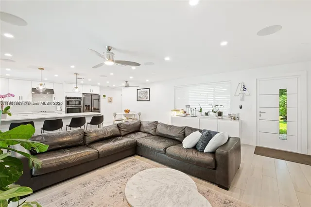 a view of a living room kitchen and a wooden floor