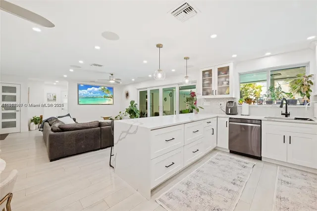 a large white kitchen with a large window